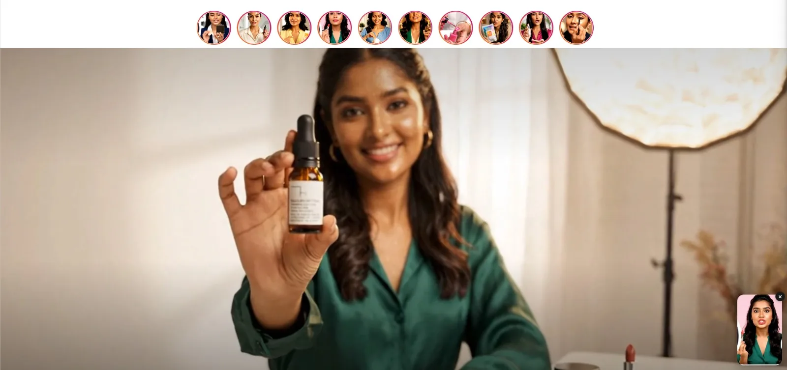 Shoppable video stories above a full-width hero video banner, with a floating video player in the corner
